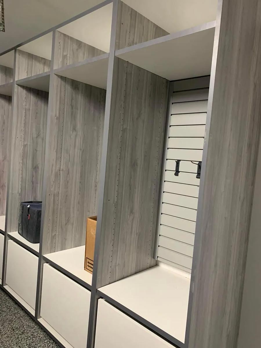 Wooden lockers with open compartments and white lower cabinets